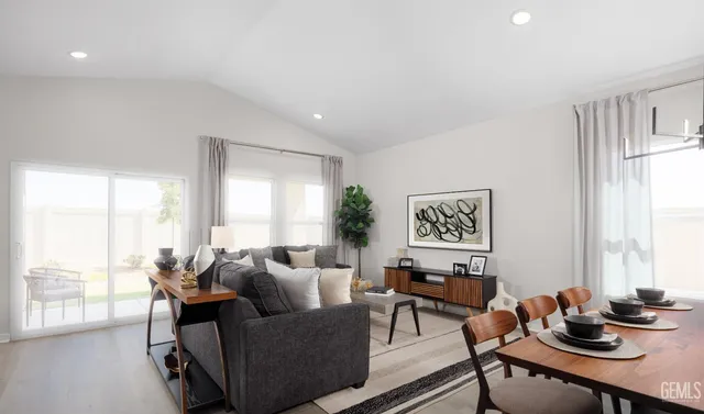 a living room with furniture a kitchen view and a sink