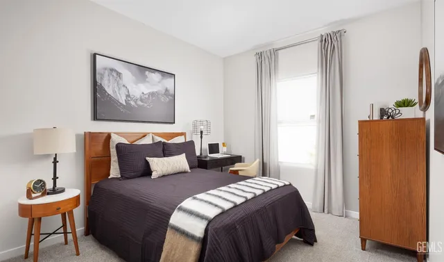 a bathroom with a granite countertop sink toilet and a mirror