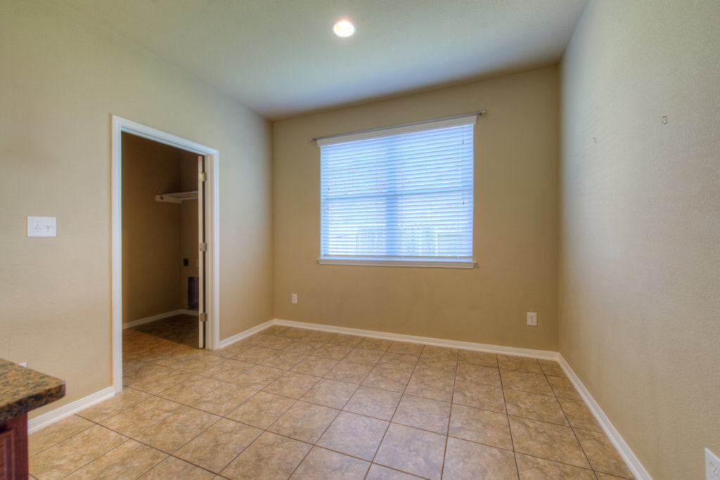 403 Limestone Trail Austin, TX 78737 - Photo 12 of 18 A well-lit utility space features tiled flooring and a convenient laundry closet.
