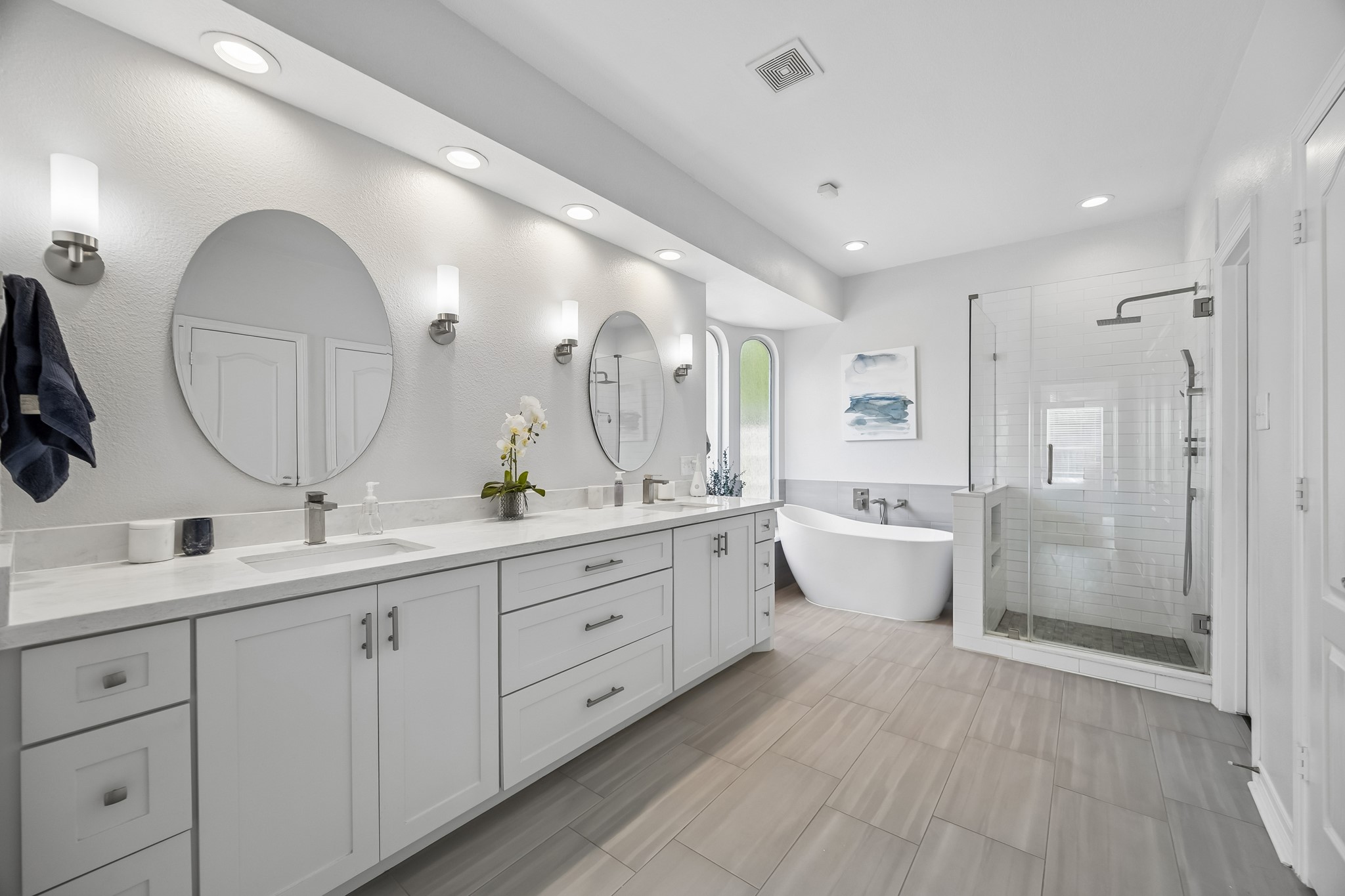 5718 Brennan Ridge Lane Katy, TX 77450 - Photo 17 of 42 FULLY RENOVATED AND BEAUTIFULLY EXECUTED: Quartz countertops, dual sinks, updated mirrors, dimmable sconce lighting, and extensive custom cabinetry deliver both style and exceptional functionality.