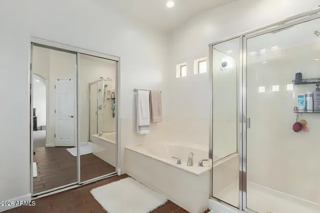a bathroom with a glass shower door and a glass door shower