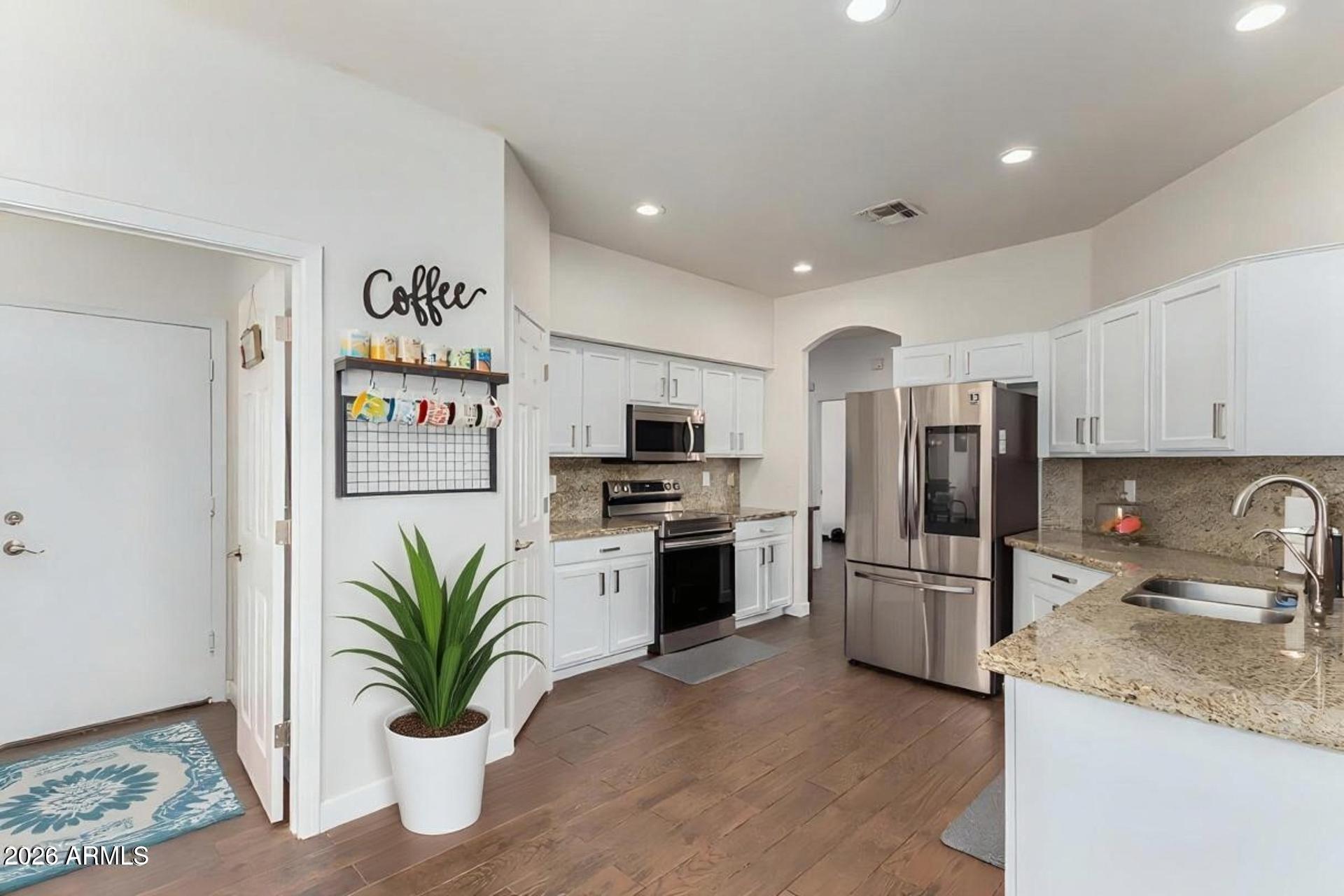 6435 South Beckham Way Laveen, AZ 85339 - Photo 3 of 14 a kitchen with stainless steel appliances granite countertop a refrigerator and a sink