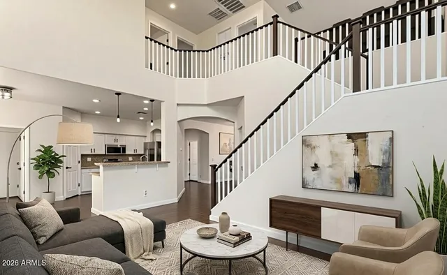 a living room with furniture kitchen view and a potted plant