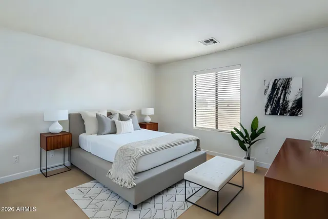 a bedroom with a bed and window