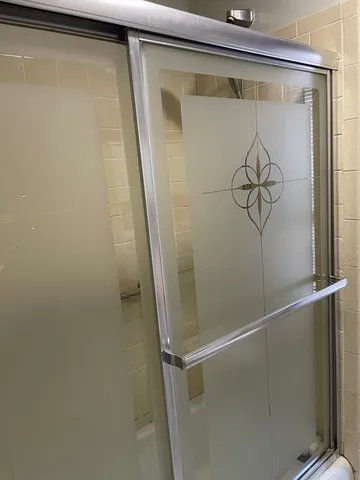a bathroom with a glass shower door