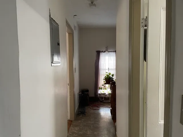 a view of a hallway with a livingroom and a dinning room