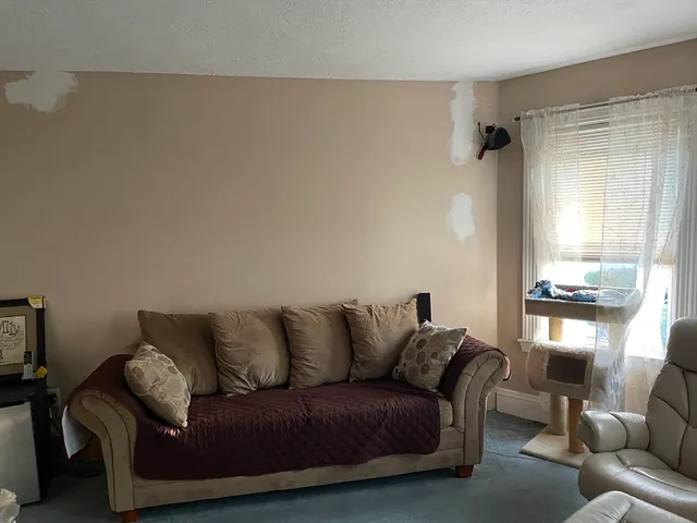 a living room with a couch and a window