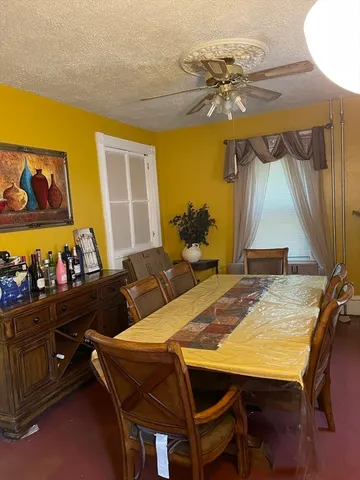 a view of a dining room with furniture and chandelier