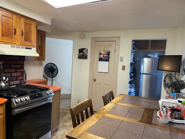 a kitchen with stainless steel appliances granite countertop a stove and a refrigerator