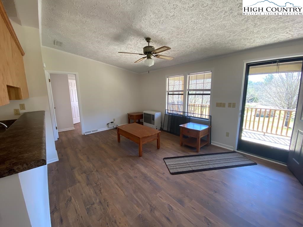 462 Hartsoe Road Warrensville, NC 28693 - Photo 3 of 17 a living room with furniture and a fireplace