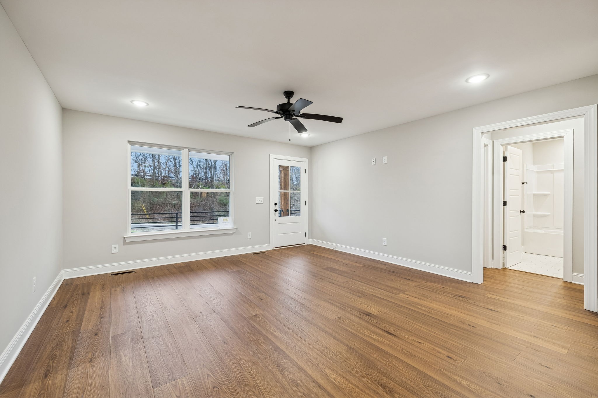 1097 Landing Lane Adams, TN 37010 - Photo 7 of 30 an empty room with wooden floor and windows