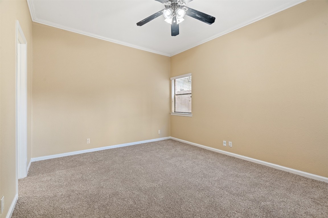 505 Bellevue Place, Unit 3 Austin, TX 78705 - Photo 20 of 23 an empty room with a window and a chandelier fan