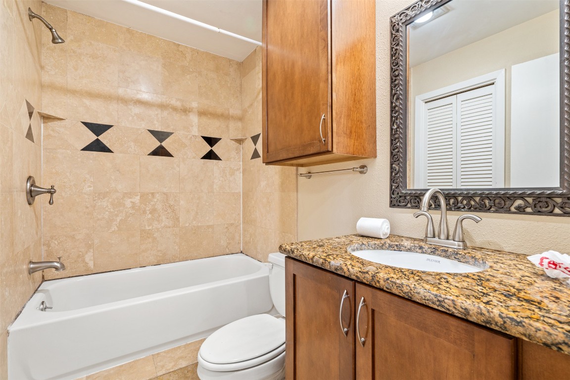 505 Bellevue Place, Unit 3 Austin, TX 78705 - Photo 23 of 23 a bathroom with a granite countertop sink a toilet and bathtub