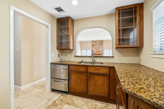 a kitchen with stainless steel appliances granite countertop a stove a sink and a refrigerator