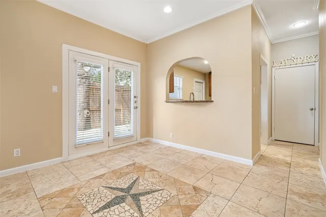 a view of an empty room with window and bathroom