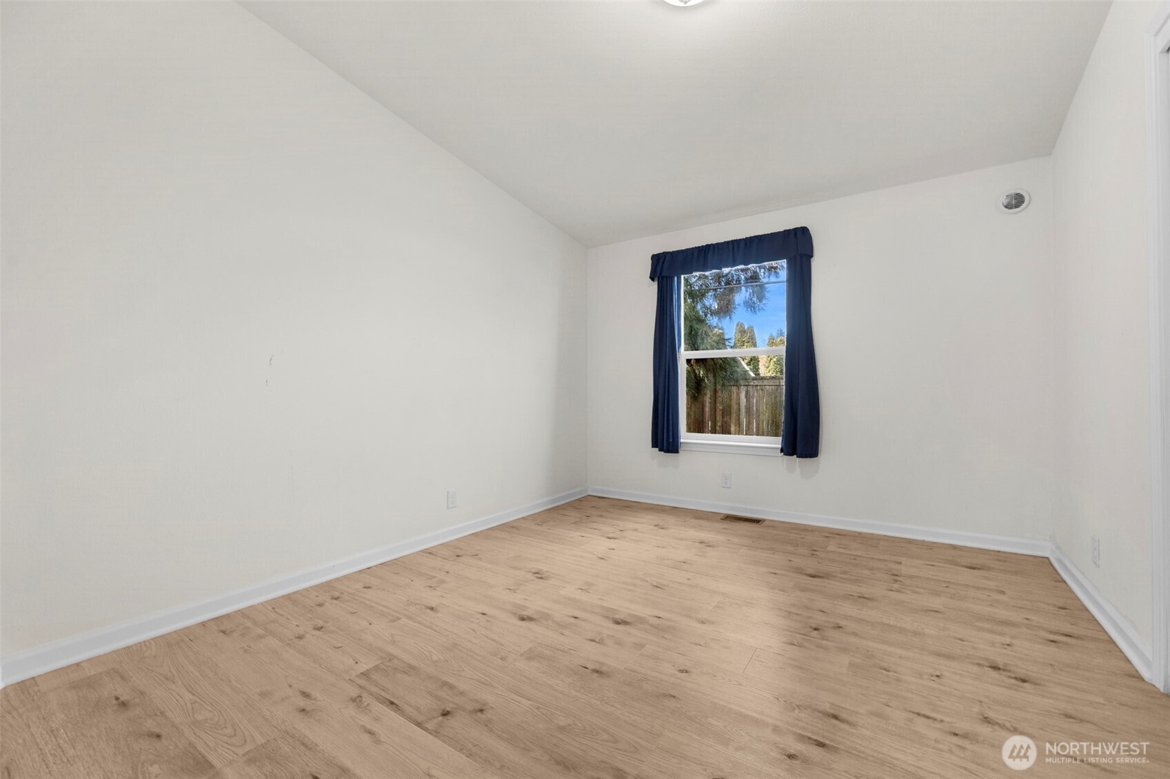 3539 Southwest 100th Street Seattle, WA 98146 - Photo 18 of 32 an empty room with wooden floor and windows