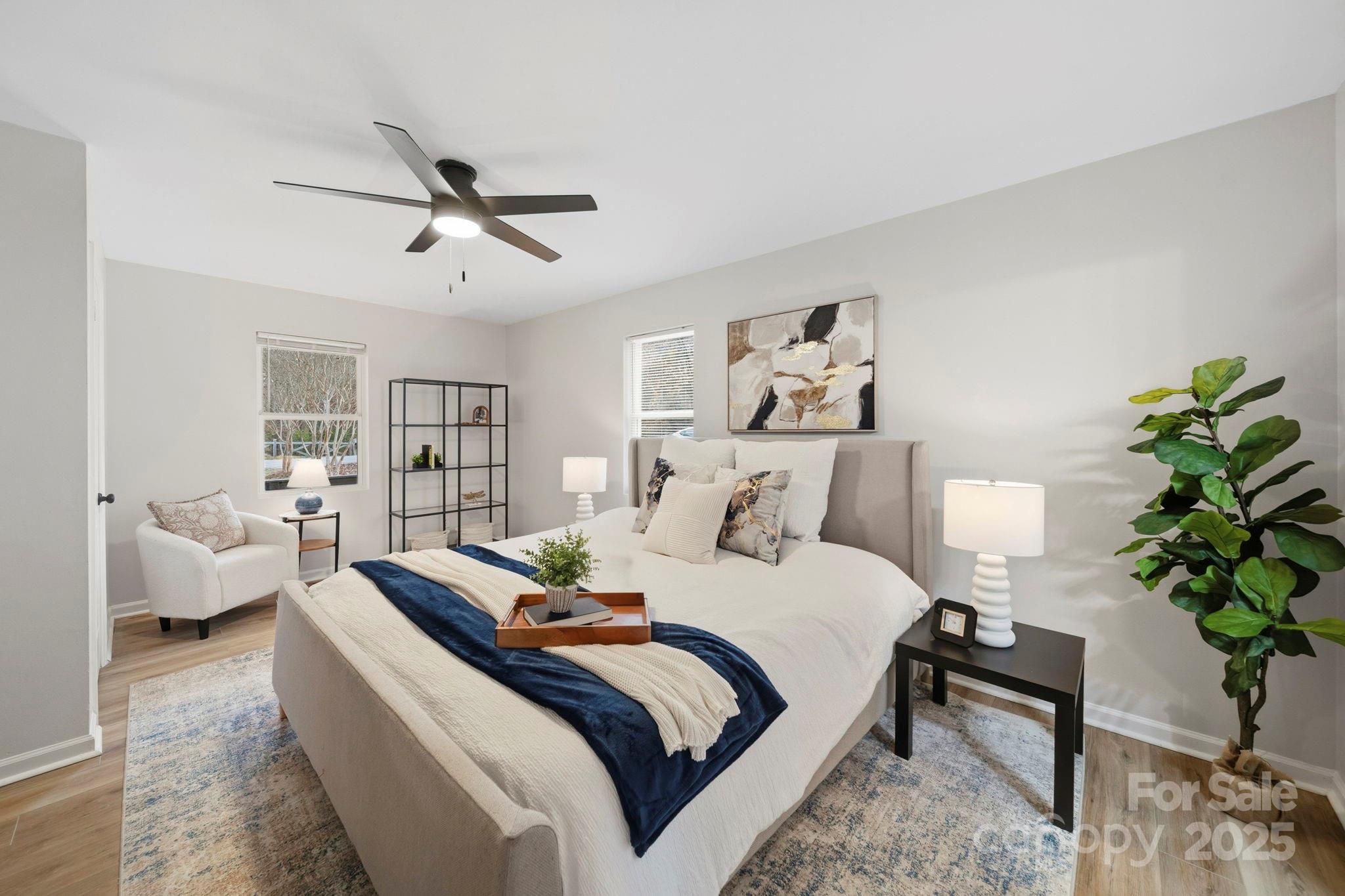 9329 Possum Hollow Road Fort Mill, SC 29707 - Photo 12 of 45 a bedroom with bed and a potted plant