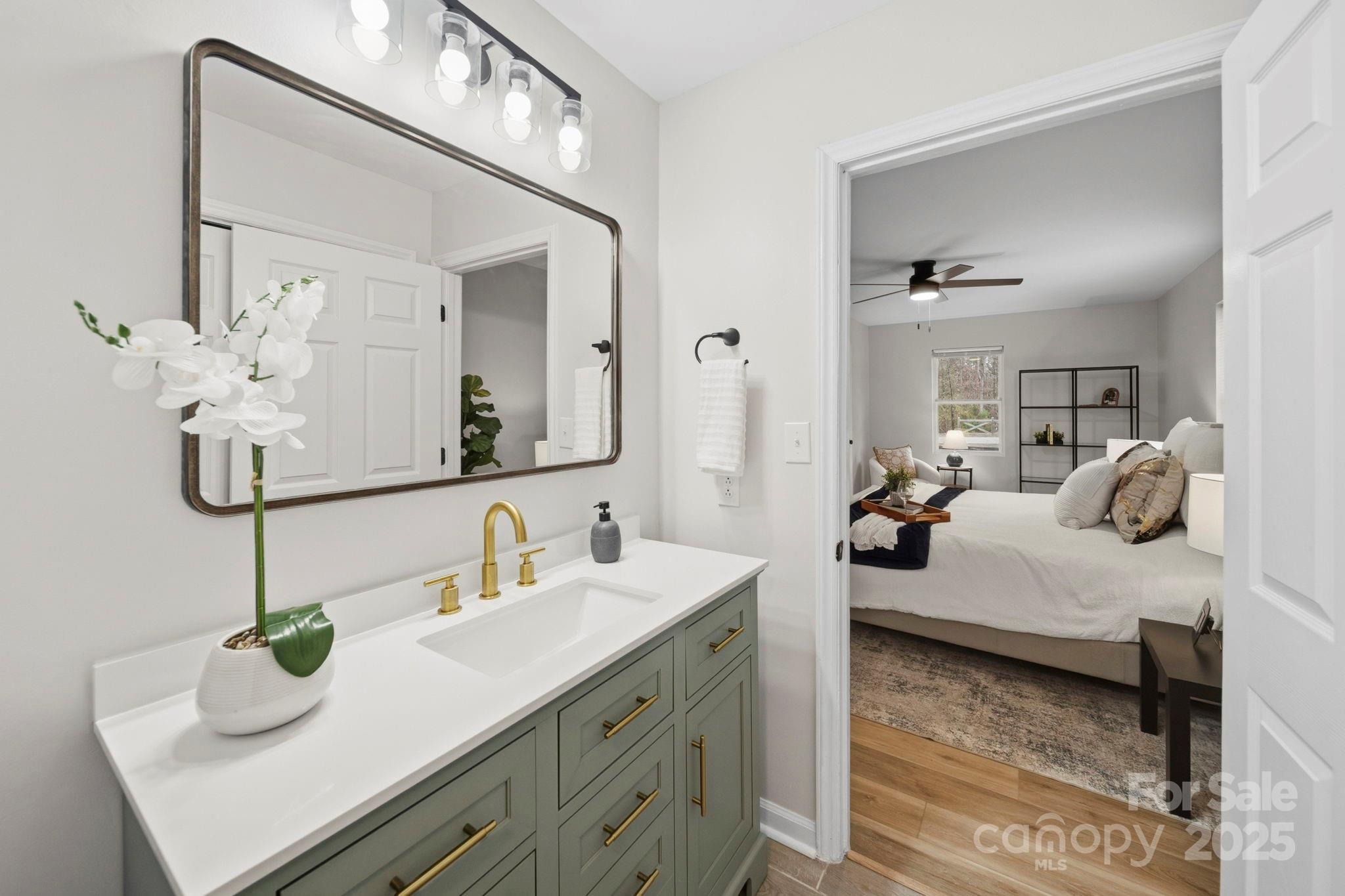 9329 Possum Hollow Road Fort Mill, SC 29707 - Photo 15 of 45 a en suite bathroom with double vanity sinks and a mirror