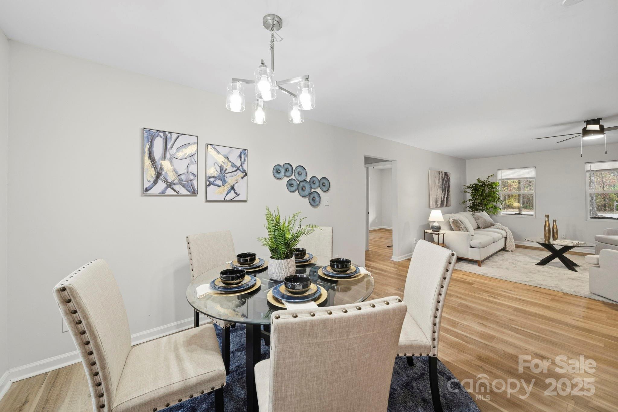 9329 Possum Hollow Road Fort Mill, SC 29707 - Photo 23 of 45 a view of a dining room with furniture and chandelier