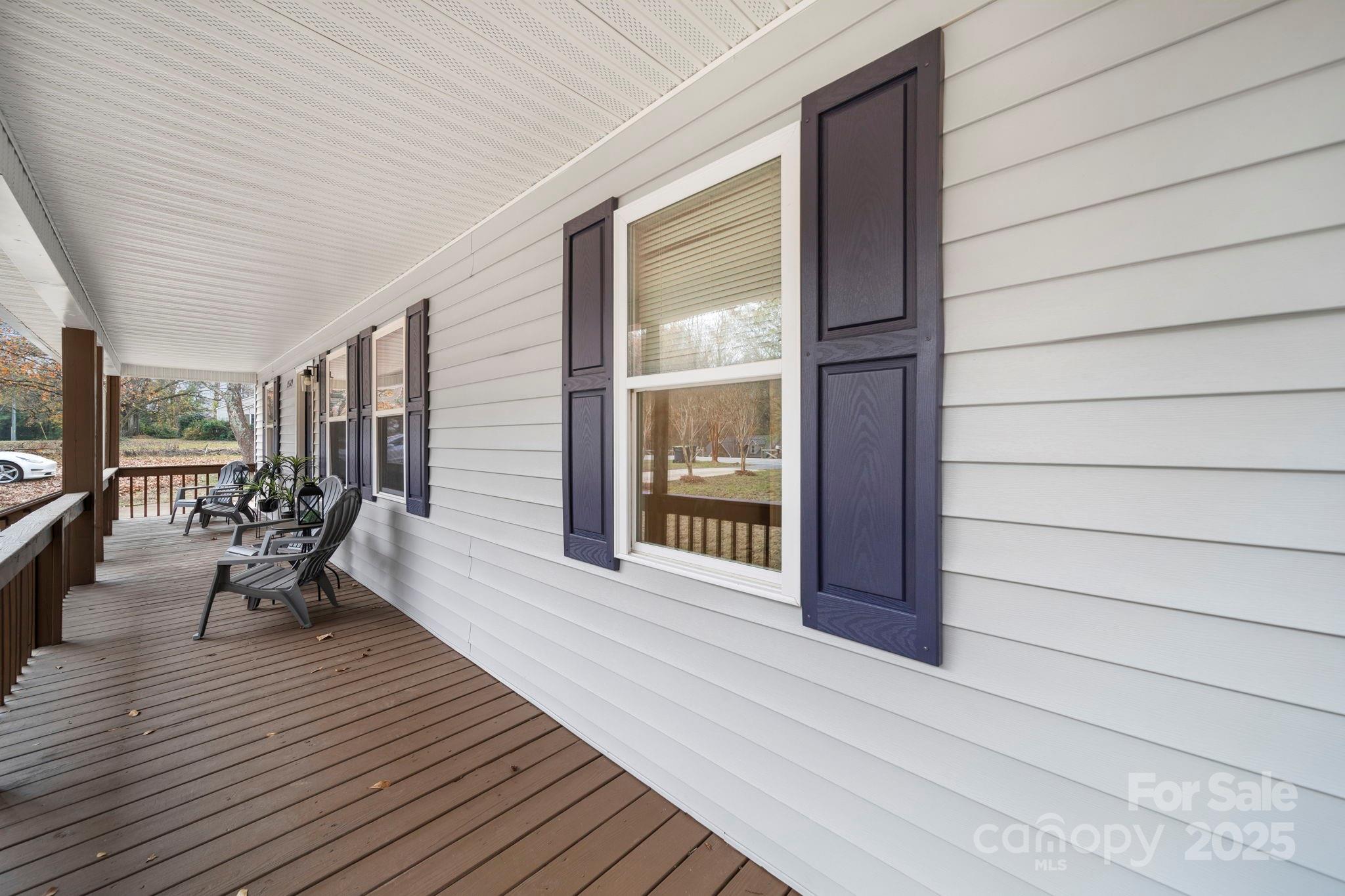 9329 Possum Hollow Road Fort Mill, SC 29707 - Photo 35 of 45 a porch with seating space and wooden floor