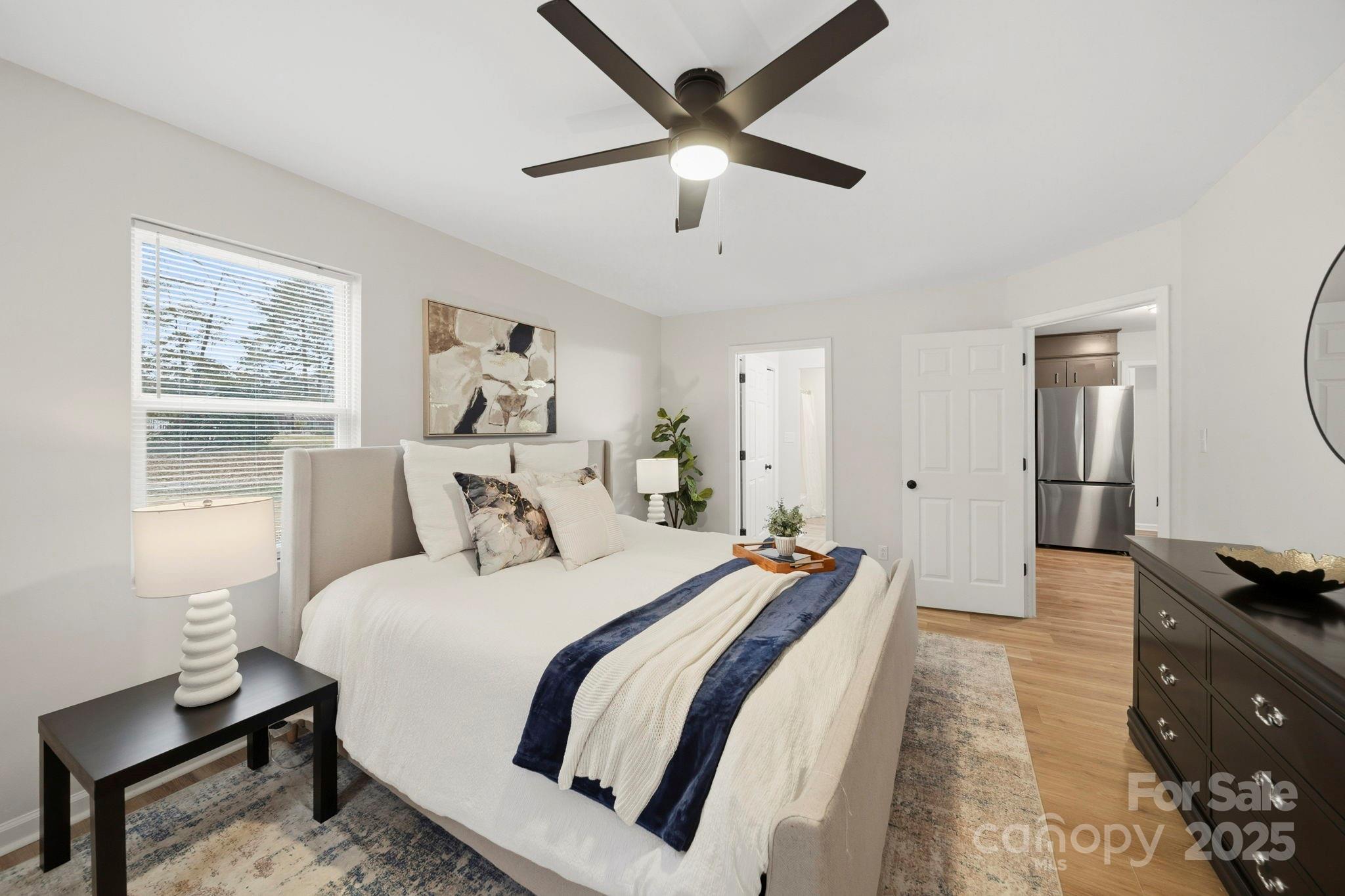 9329 Possum Hollow Road Fort Mill, SC 29707 - Photo 10 of 45 a bedroom with a bed and wooden floor