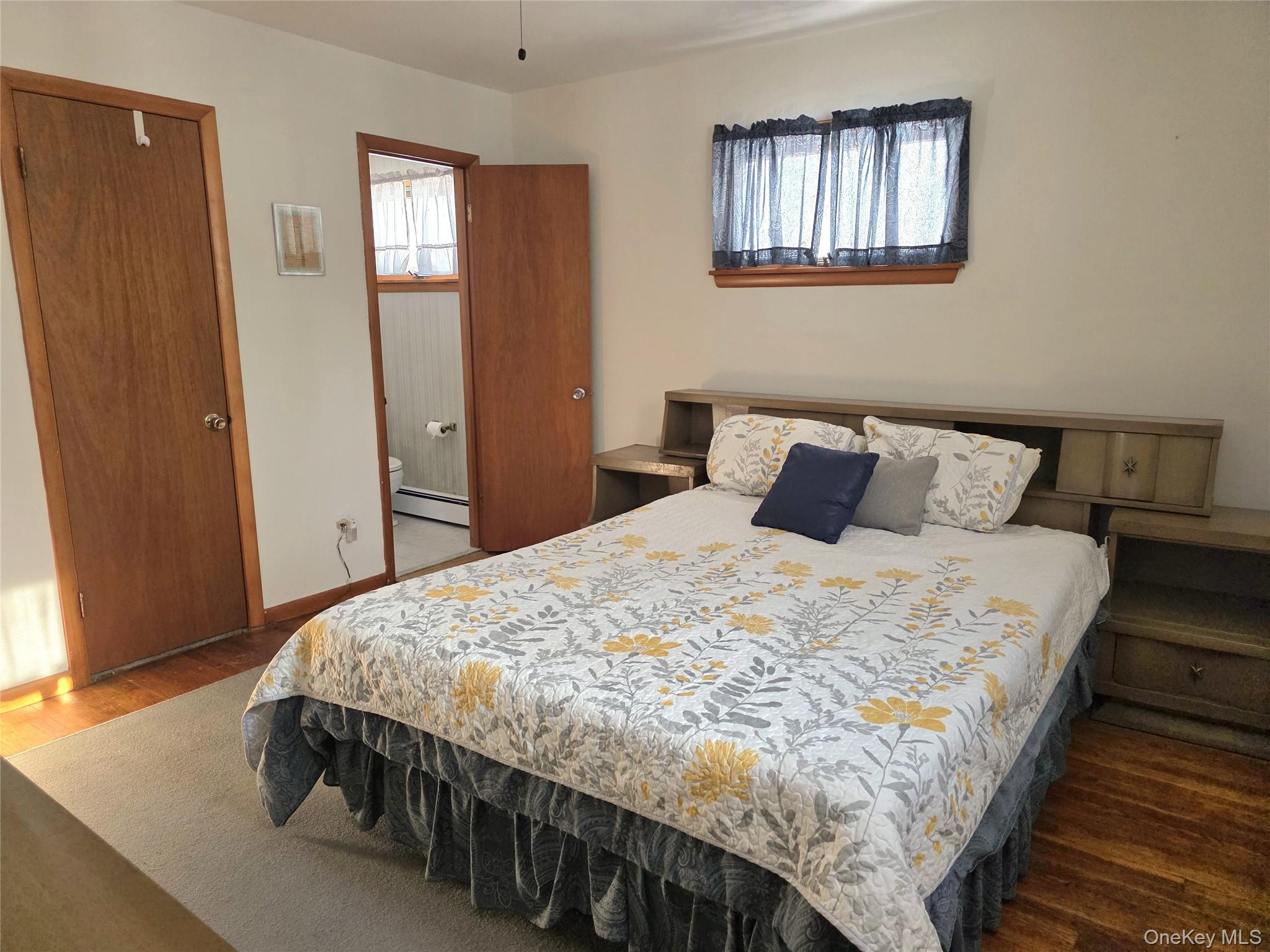 94 Whangtown Road Carmel, NY 10512 - Photo 8 of 12 a bedroom with a bed and wooden floor