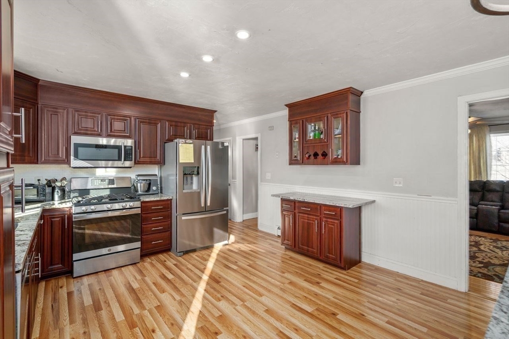 231 Lapham Street Fall River, MA 02721 - Photo 7 of 20 a kitchen with stainless steel appliances granite countertop a refrigerator stove top oven and sink