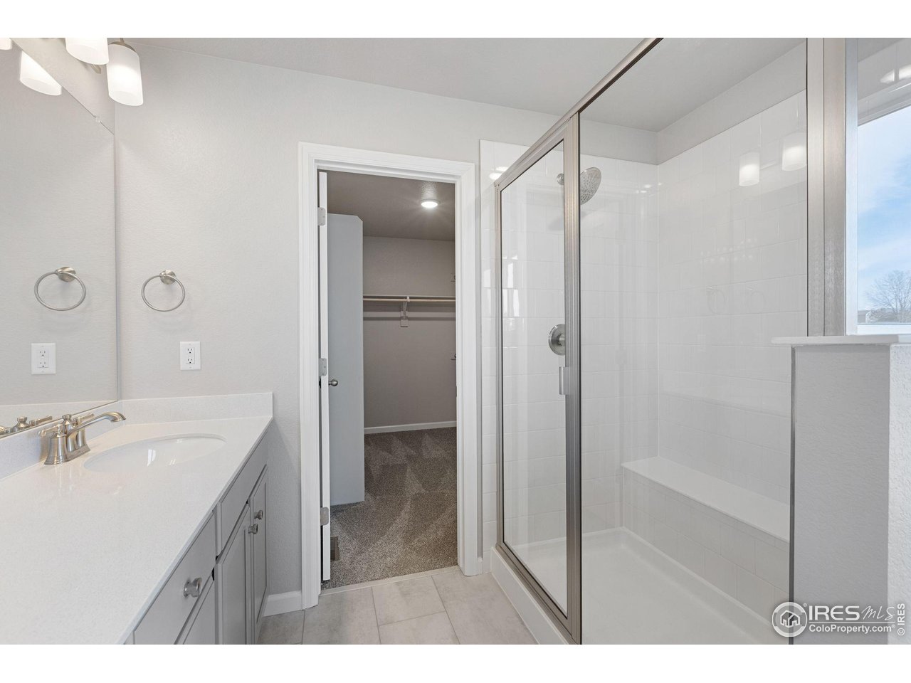 16953 Ballinger Circle Mead, CO 80542 - Photo 17 of 27 a bathroom with a shower sink vanity and mirror