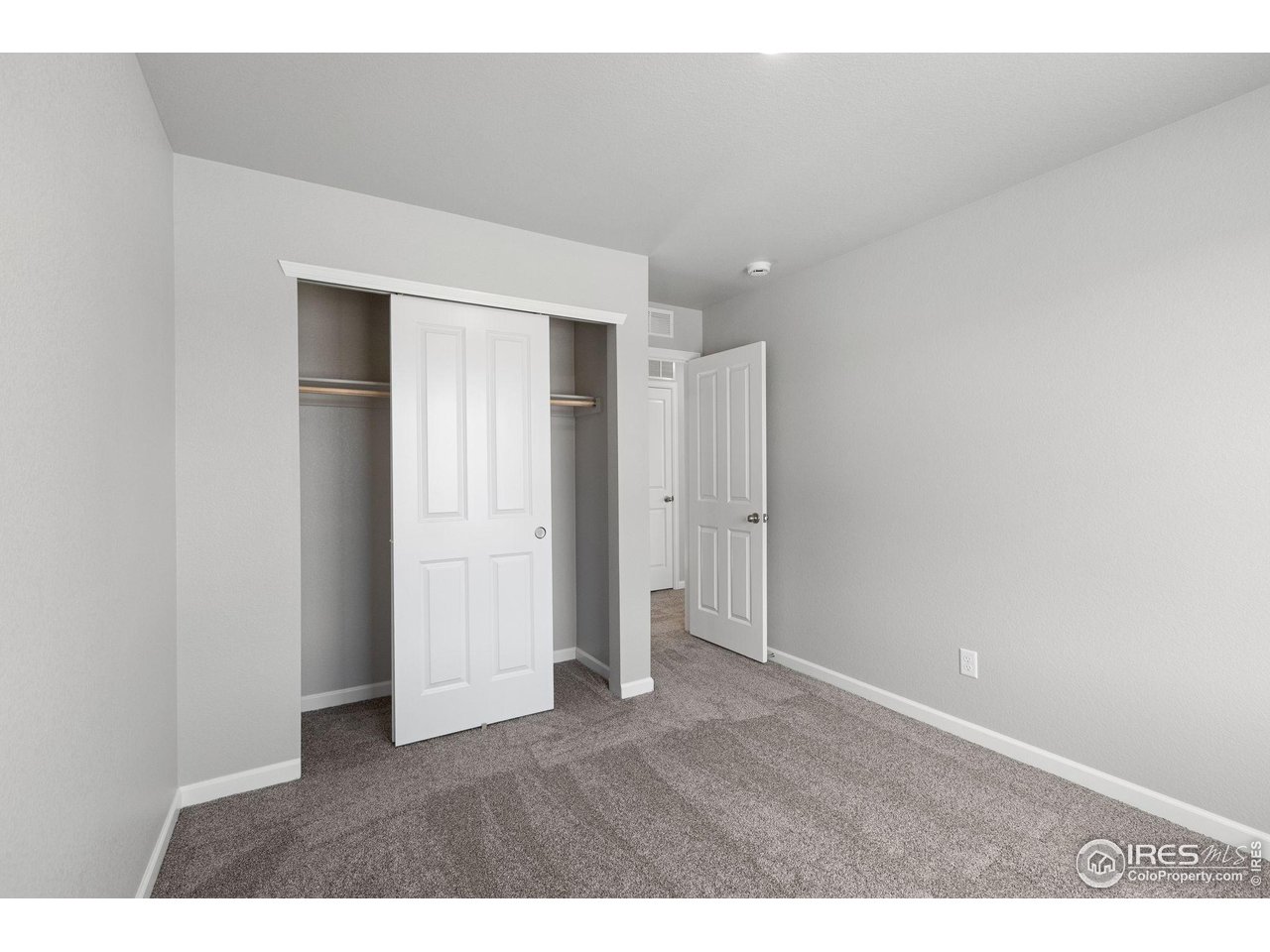 16953 Ballinger Circle Mead, CO 80542 - Photo 20 of 27 a view of an empty room with wooden floor