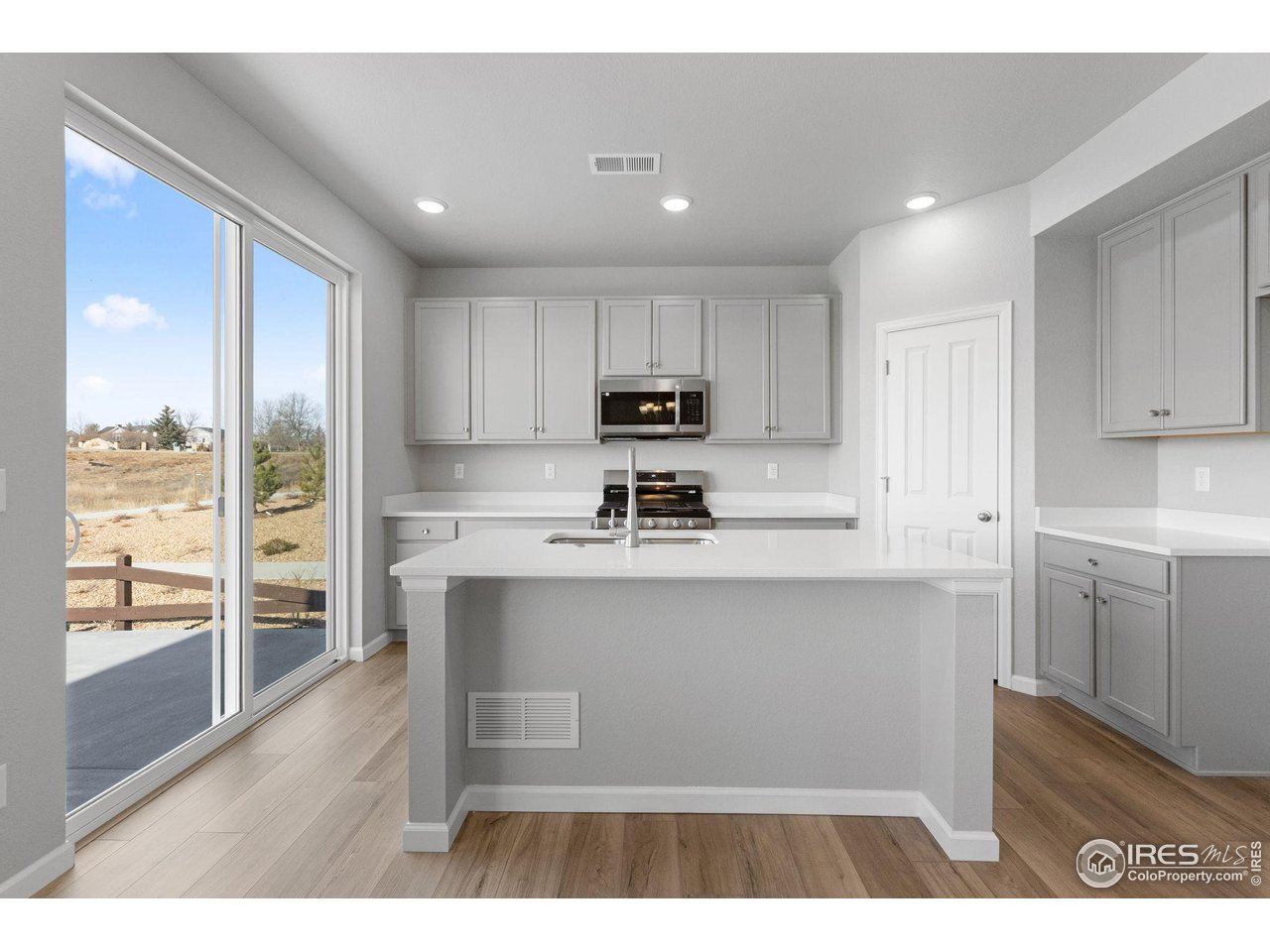 16953 Ballinger Circle Mead, CO 80542 - Photo 2 of 27 a living room with stainless steel appliances granite countertop a refrigerator sink and cabinets