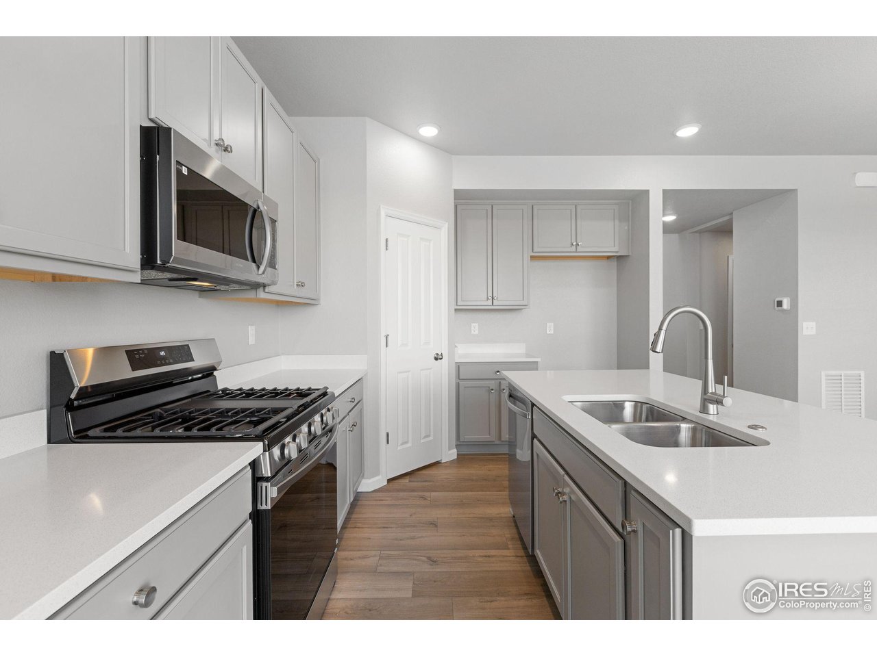 16953 Ballinger Circle Mead, CO 80542 - Photo 4 of 27 a kitchen that has a sink and a stove