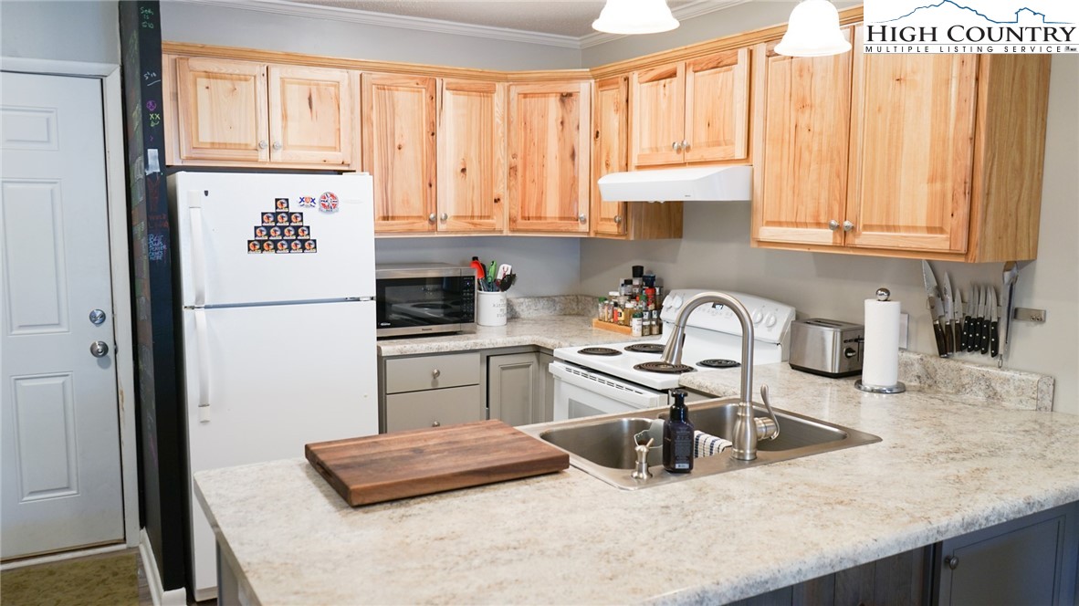 475 Meadowview Drive, Unit B306 Boone, NC 28607 - Photo 2 of 14 a kitchen with granite countertop a sink a stove and refrigerator