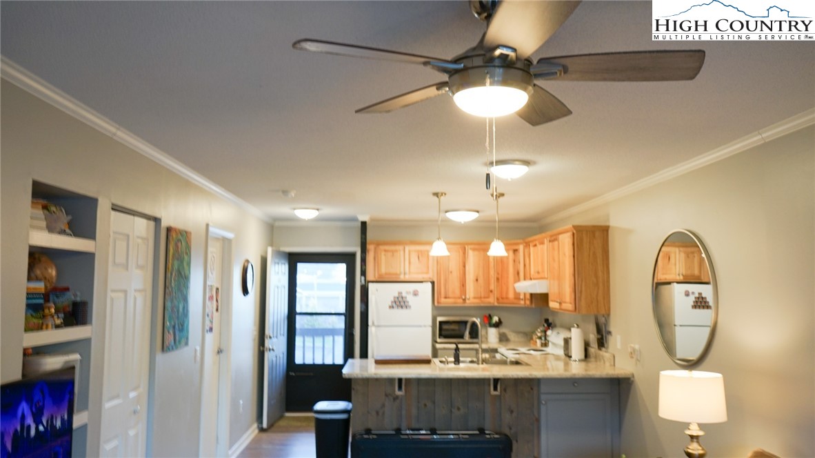 475 Meadowview Drive, Unit B306 Boone, NC 28607 - Photo 3 of 14 a view of a kitchen with granite countertop a window and a chandelier