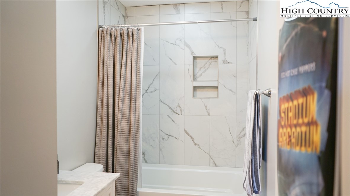 475 Meadowview Drive, Unit B306 Boone, NC 28607 - Photo 10 of 14 a bathroom with a shower and a toilet