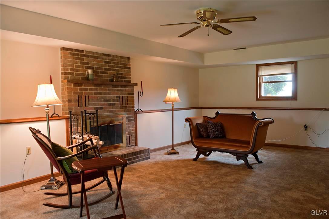 214 Ruth Road Bath, PA 18014 - Photo 17 of 25 a living room with furniture a fireplace and a chandelier