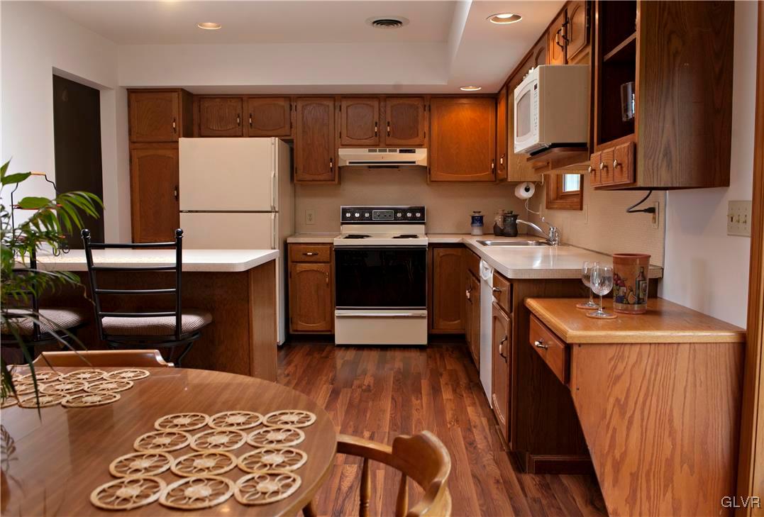 214 Ruth Road Bath, PA 18014 - Photo 8 of 25 a kitchen with stainless steel appliances granite countertop a stove a sink and a refrigerator