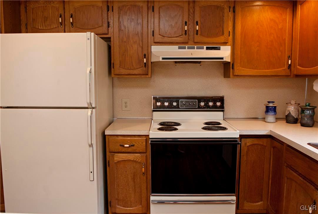 214 Ruth Road Bath, PA 18014 - Photo 10 of 25 a kitchen with stainless steel appliances granite countertop a stove a refrigerator and a sink
