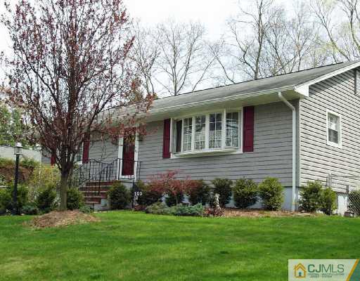 125 Normandy Road Colonia, NJ 07067 - Photo 1 of 10 a front view of a house with a garden