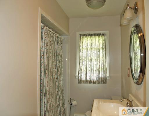 125 Normandy Road Colonia, NJ 07067 - Photo 8 of 10 a bathroom with a shower curtain and a window