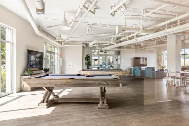 a living room with lots of furniture and a table