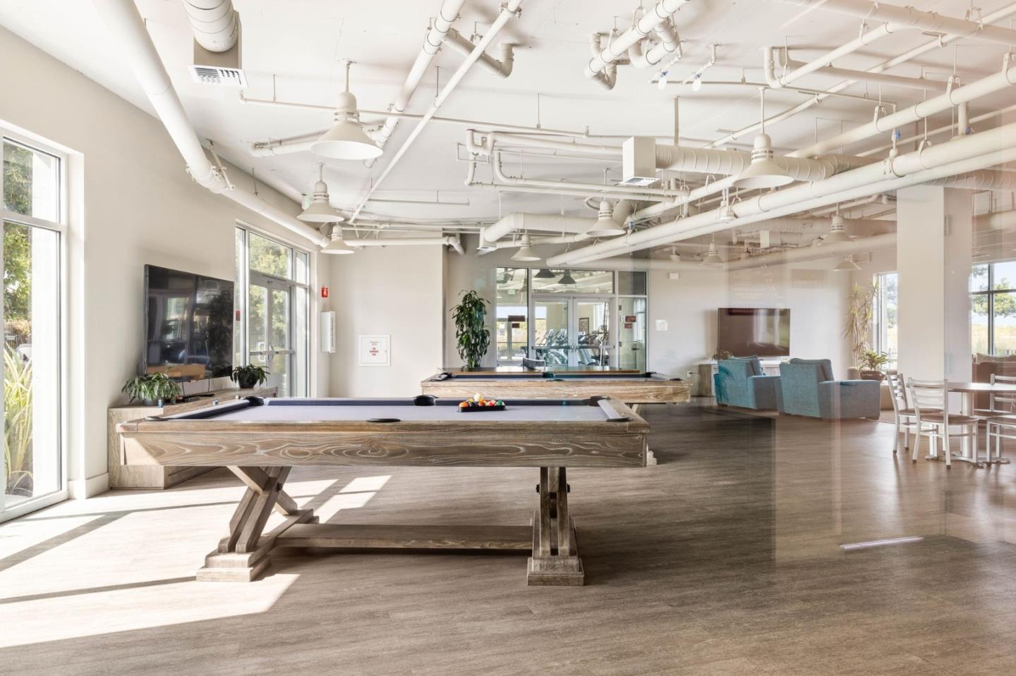400 Mariners Island Boulevard, Unit 202 San Mateo, CA 94404 - Photo 18 of 31 a living room with lots of furniture and a table