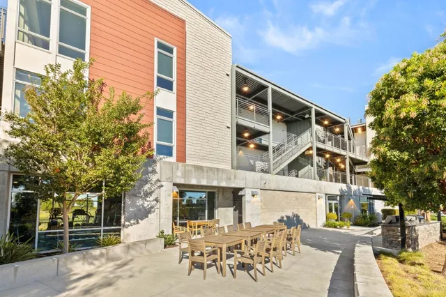 a view of a porch with wooden floor and iron stairs
