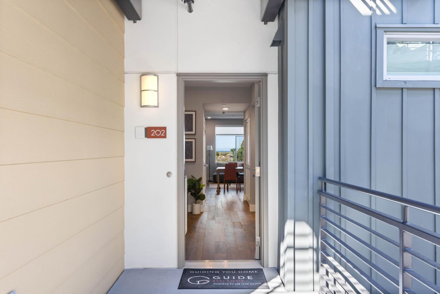 400 Mariners Island Boulevard, Unit 202 San Mateo, CA 94404 - Photo 4 of 31 a view of a hallway with a livingroom and dinning room with a mirror