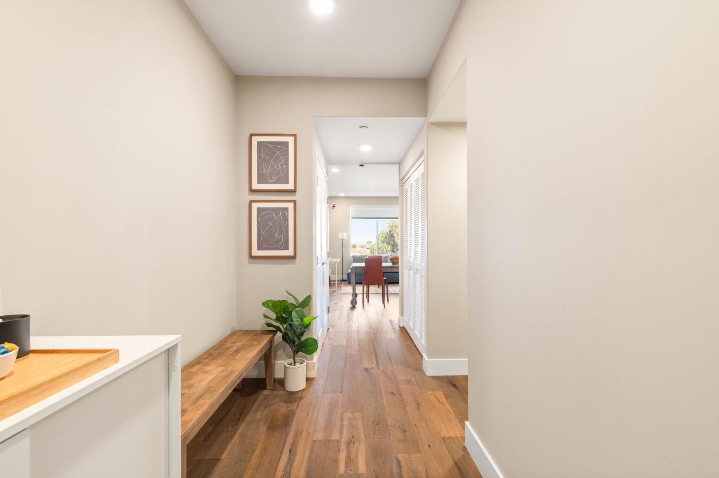 400 Mariners Island Boulevard, Unit 202 San Mateo, CA 94404 - Photo 5 of 31 a hallway with a dining table chairs wooden floors and a large window