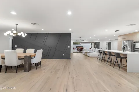 a view of a dining room with furniture and wooden floor