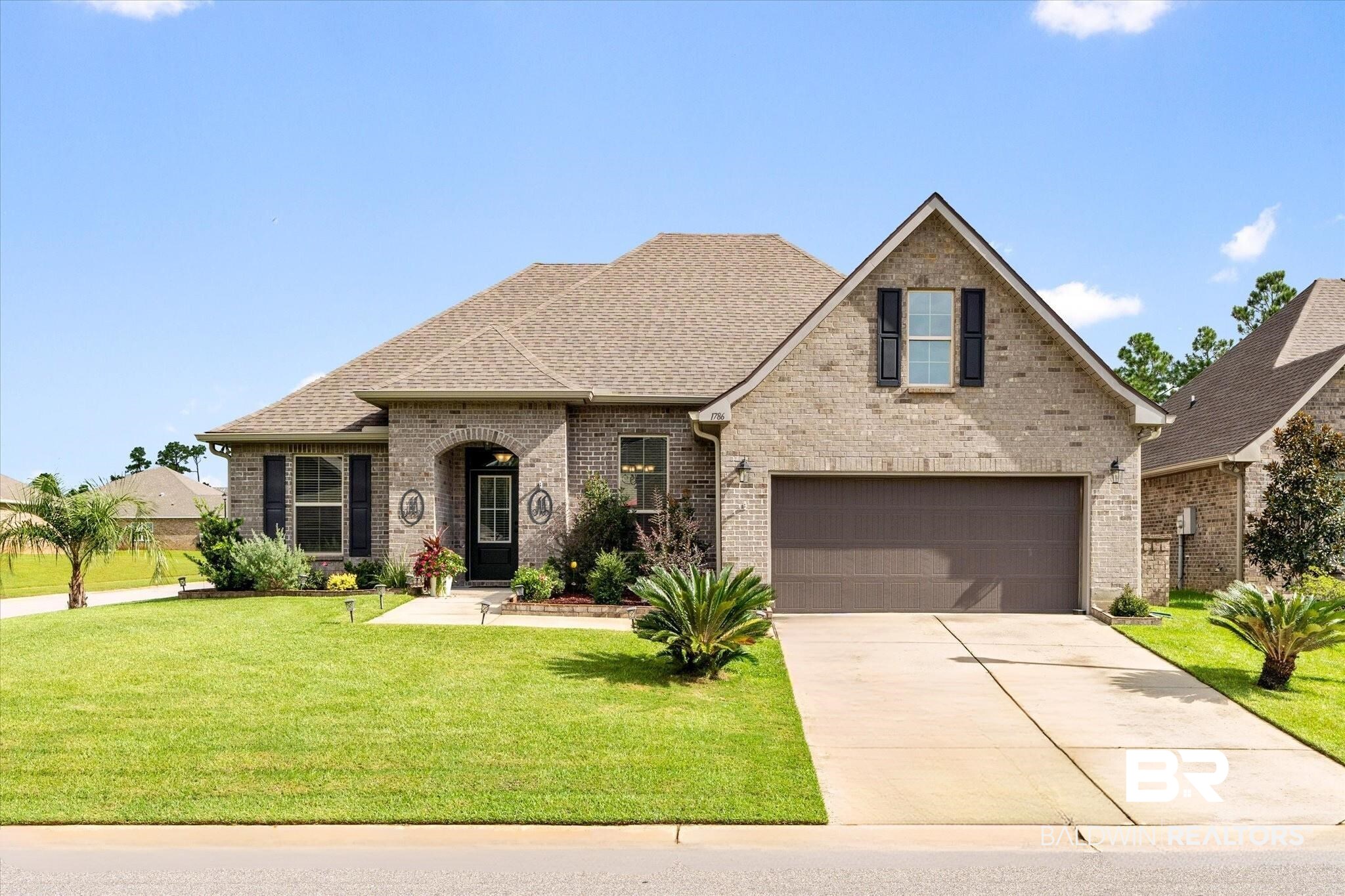 1786 Vivace Drive Foley, AL 36535 - Photo 2 of 21 View of front of house with brick siding, roof with shingles, a front yard, and concrete driveway