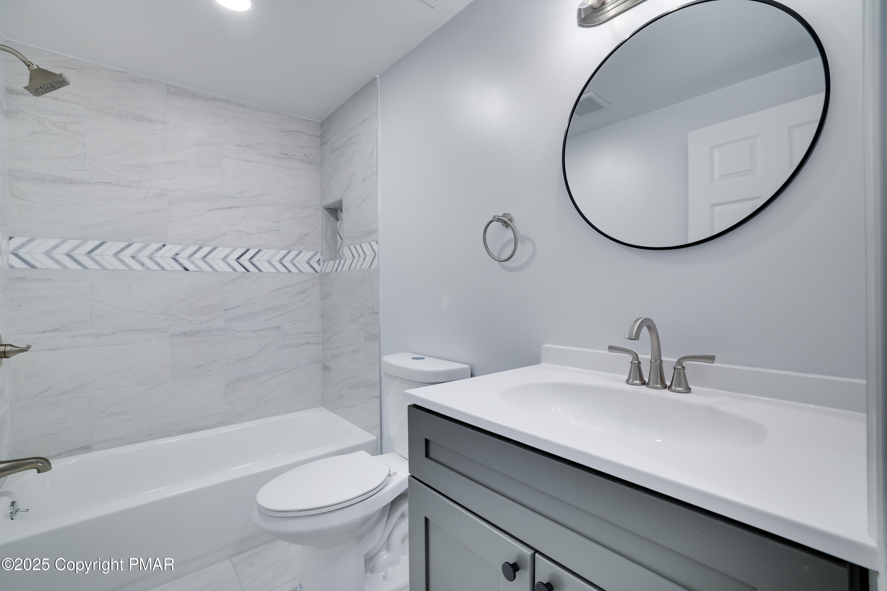 523 Sarah Street, Unit C Stroudsburg, PA 18360 - Photo 12 of 16 a bathroom with a sink a toilet and a mirror