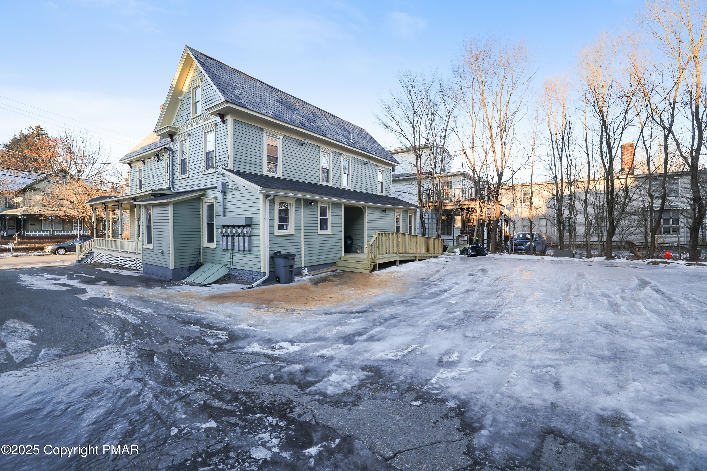 523 Sarah Street, Unit C Stroudsburg, PA 18360 - Photo 16 of 16 a view of a house with a yard covered in snow
