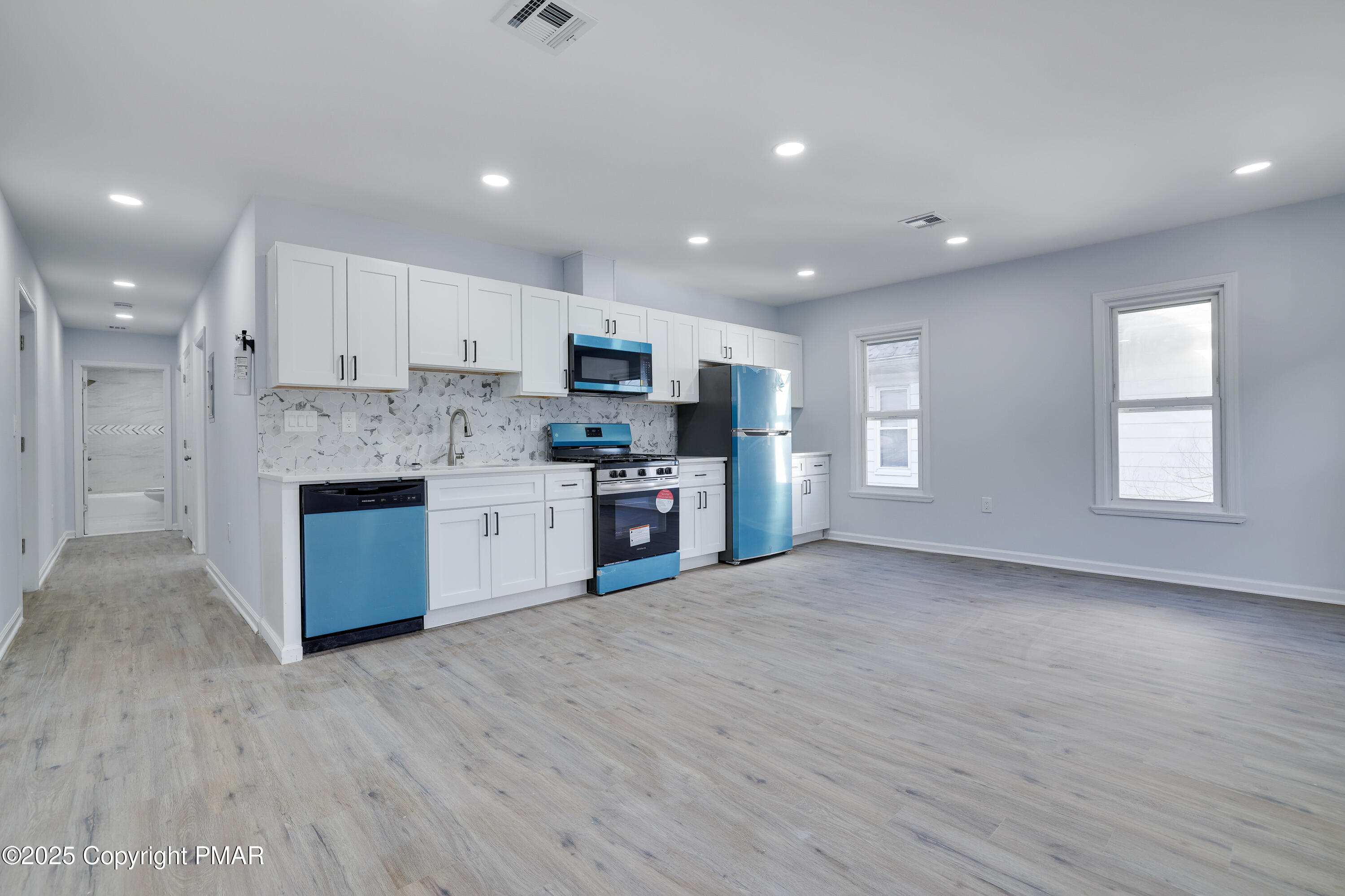 523 Sarah Street, Unit C Stroudsburg, PA 18360 - Photo 4 of 16 a large kitchen with stainless steel appliances granite countertop a stove a sink and a refrigerator