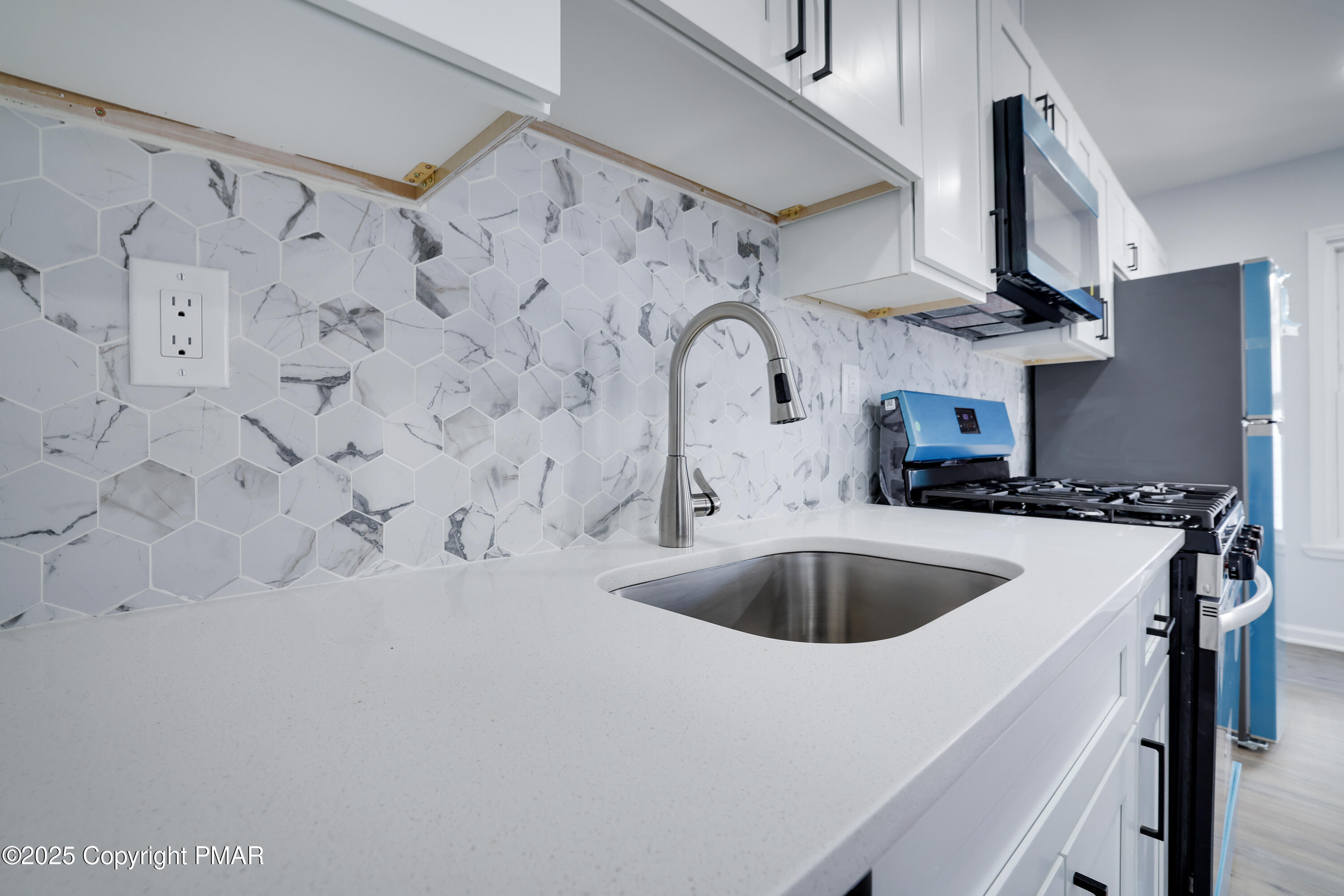 523 Sarah Street, Unit C Stroudsburg, PA 18360 - Photo 6 of 16 a kitchen with stainless steel appliances a sink a stove and refrigerator